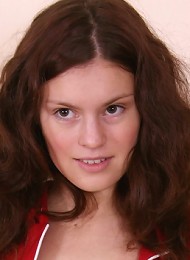 Sexy brunette girl bares her tight pussy and spreads